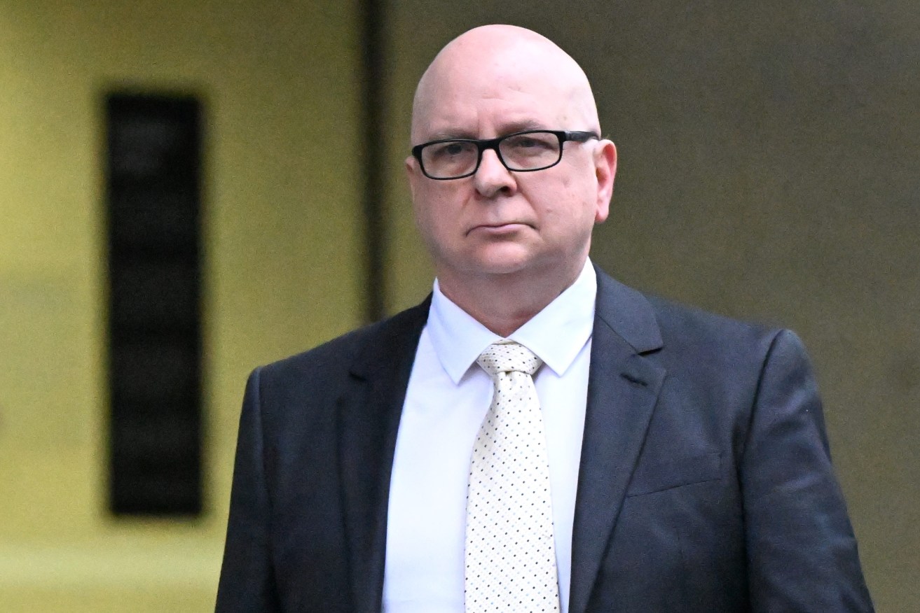 Police officer Anthony John Clowes is seen outside the Brisbane District Court in Brisbane, Monday, July 8, 2024. Clowes has pleaded not guilty in a Brisbane court to allegedly raping a female colleague after they both attended a Christmas party in 1999. (AAP Image/Darren England) 